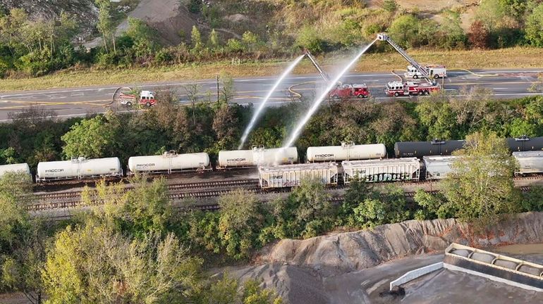 Firefighters work on the scene of a chemical leak in...