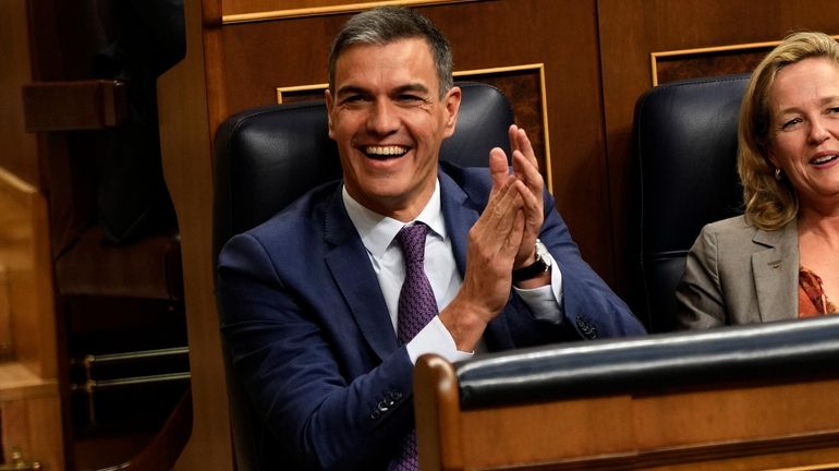 Acting Prime Minister Pedro Sanchez applauds at the Spanish parliament's...