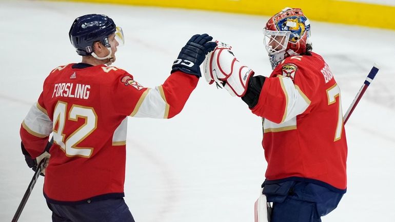 Florida Panthers defenseman Gustav Forsling (42) greets goaltender Sergei Bobrovsky...