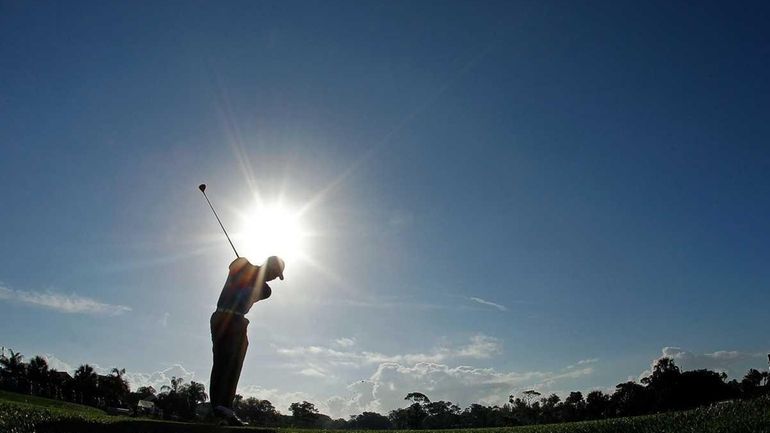 Tiger Woods hits his tee shot on the 12th hole...