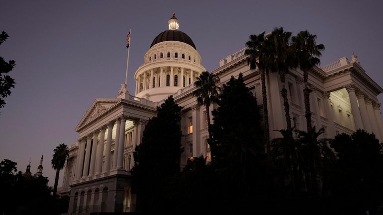 The lights of the state Capitol glow into the night...