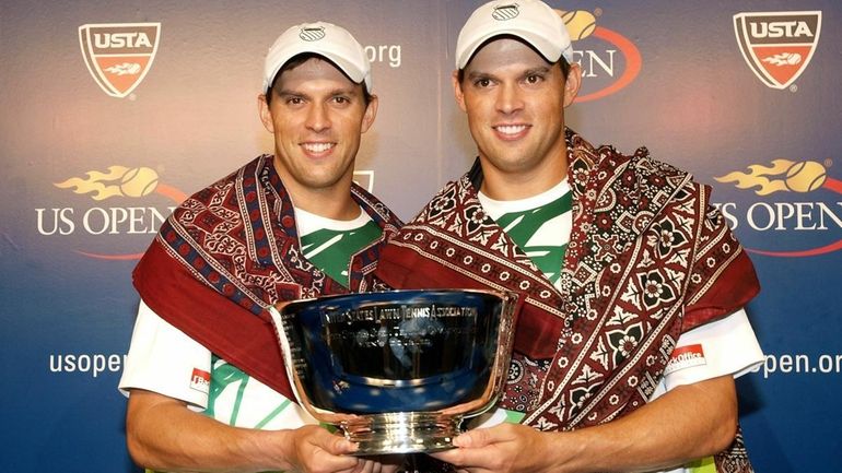 Mike Bryan and Bob Bryan of the United States hold...