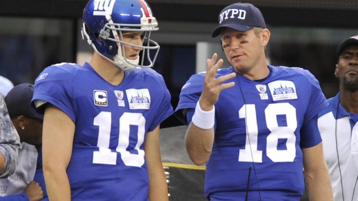 New York Giant Eli Manning wears a NYPD hat on the sidelines. The