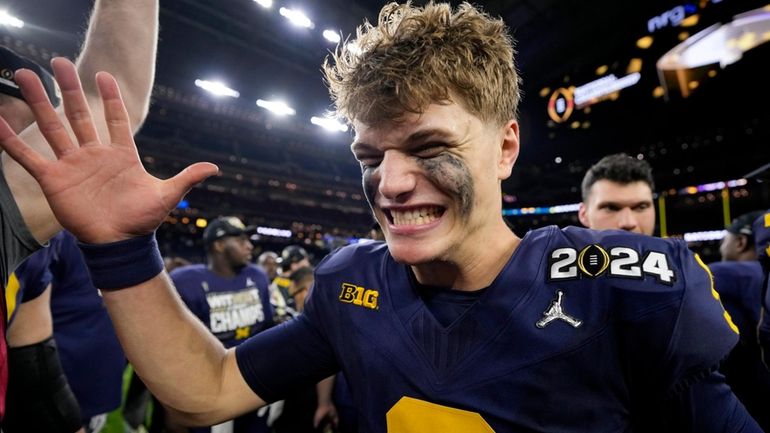 Michigan quarterback J.J. McCarthy celebrates their win against Washington in...