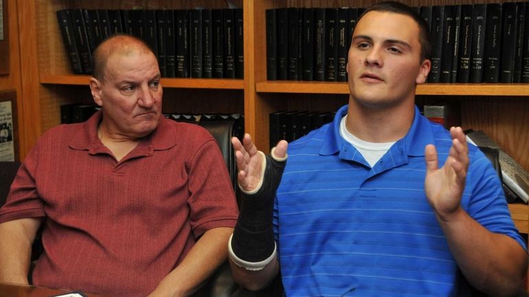 Billy Andrle, right, with his dad William, speak to the...