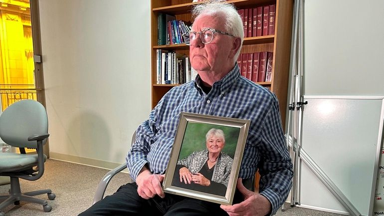 Michael Kruzich holds a photo of his late mother, Donna...