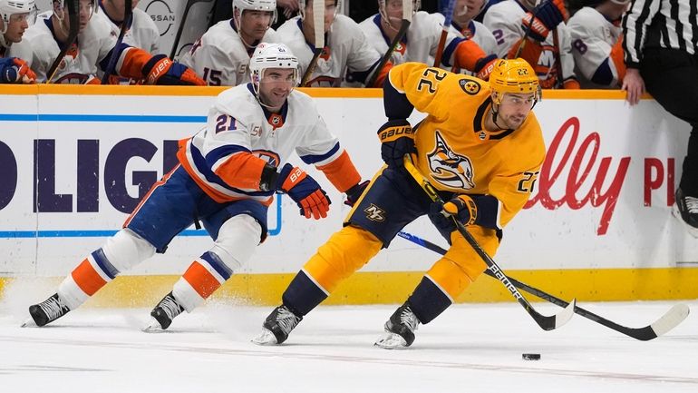 Nashville Predators' Nino Niederreiter (22) moves the puck ahead of Islanders'...