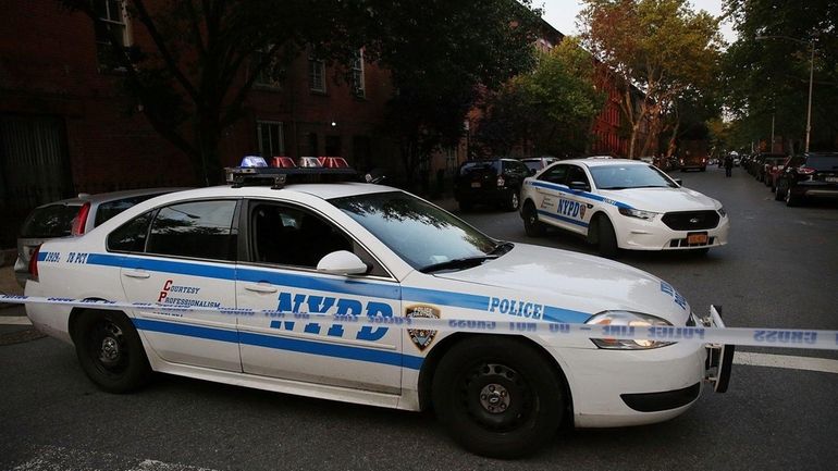 A police car is parked at a crime scene where...