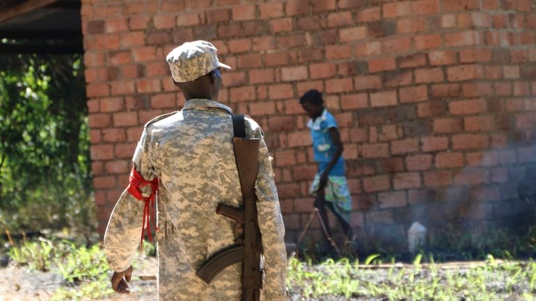 A soldier walks through a market outside of Yei town...