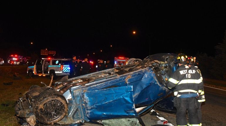 First responders work at the scene of the accident on...