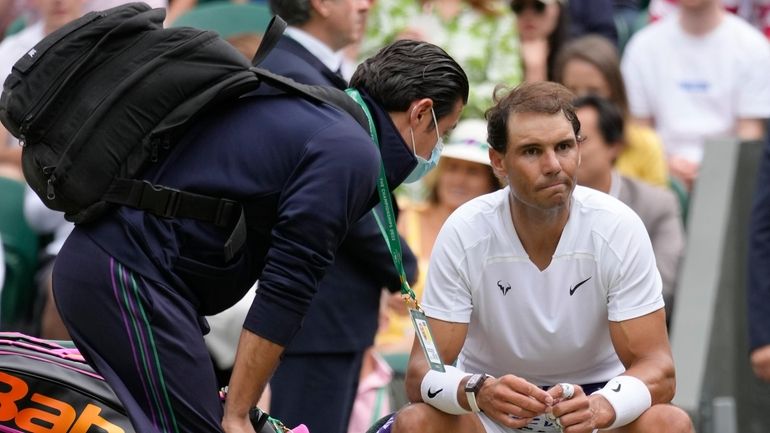 Spain's Rafael Nadal receives treatment just before a medical timeout...