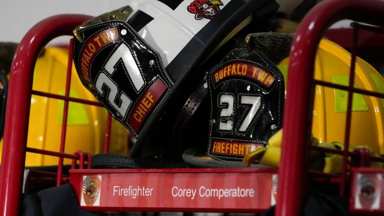 Helmets rest on the locker of firefighter Corey Comperatore at...