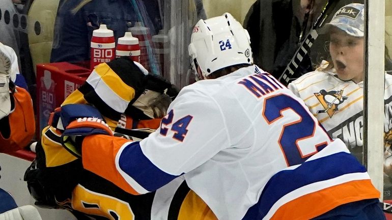 New York Islanders defenseman Scott Mayfield checks Pitsburgh Penguins left...