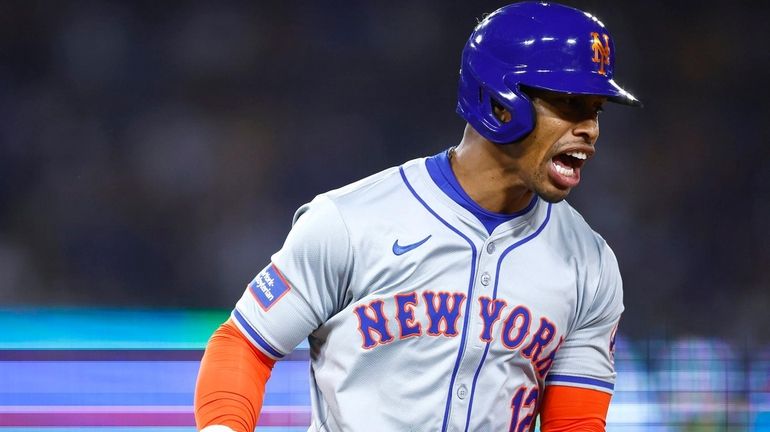 Francisco Lindor #12 of the Mets celebrates a two-run home run...