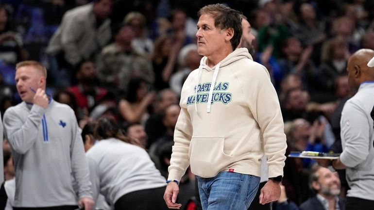 Dallas Mavericks team owner Mark Cuban walks to his seat...