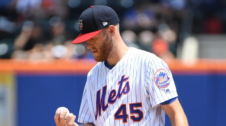 New York Mets starting pitcher Zack Wheeler reacts against the...