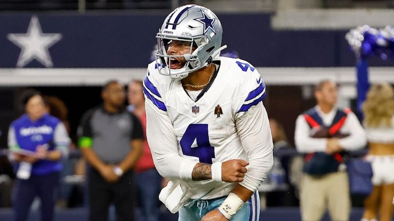 Dallas Cowboys quarterback Dak Prescott (4) celebrates after throwing a...