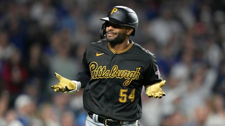 Pittsburgh Pirates' Joshua Palacios reacts toward teammates in the dugout...