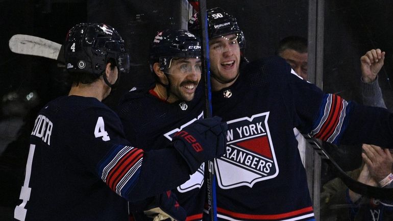 Rangers left wing Will Cuylle, right, celebrates his goal with...