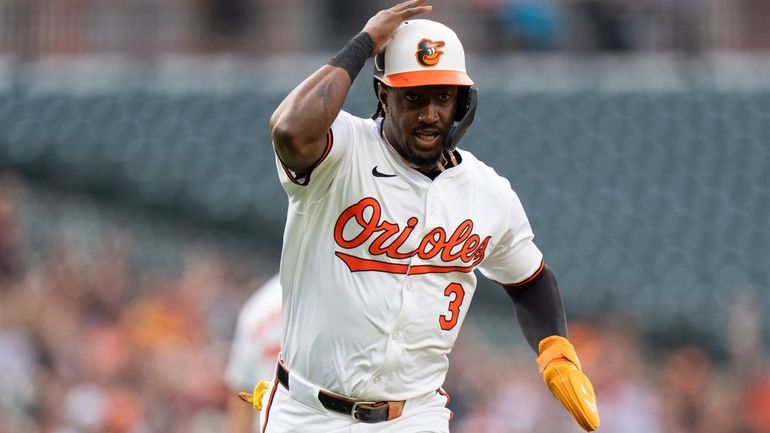Baltimore Orioles' Jorge Mateo heads home to score on a...