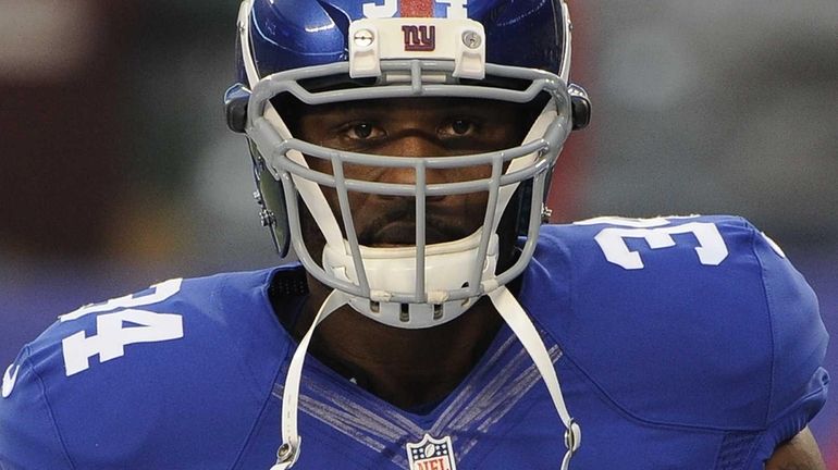 Brandon Jacobs looks on before a game against the Green...