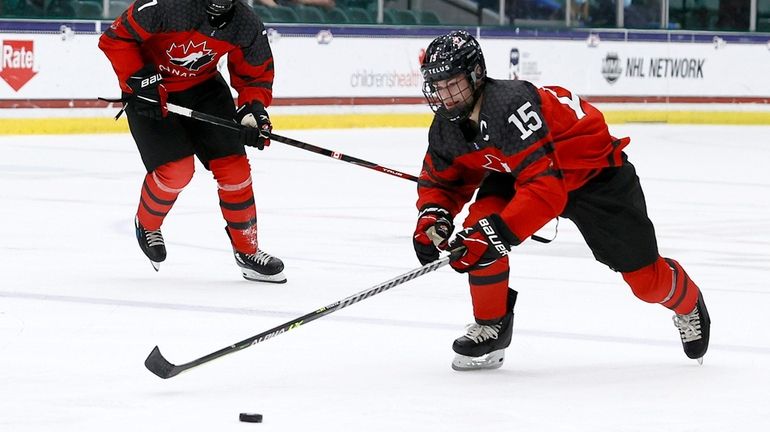 Shane Wright of Canada controls the puck against Russia in the...