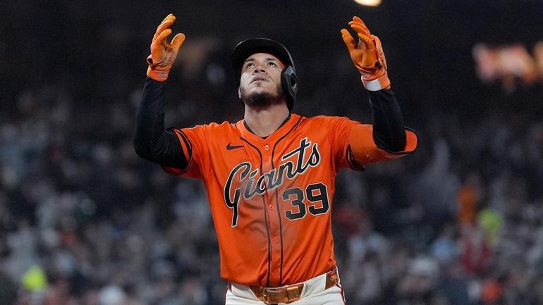 San Francisco Giants' Thairo Estrada celebrates a three-run home run...