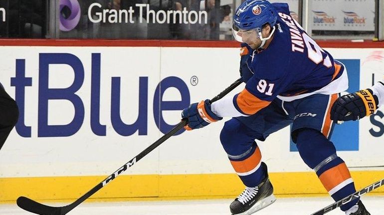 New York Islanders center John Tavares skates with the puck...