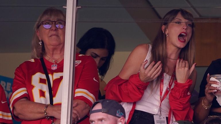 Taylor Swift, right, watches from a suite alongside Travis Kelce's...