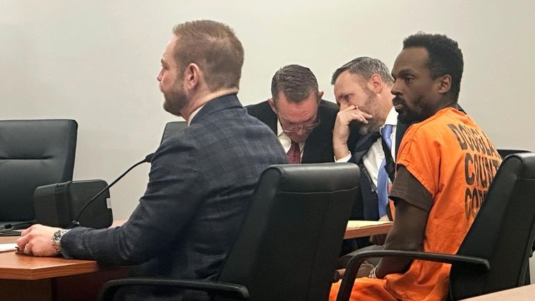 Kierre Williams, right, sits with his attorneys in court, Jan....