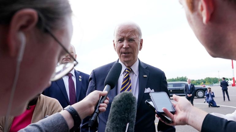 President Joe Biden speaks to the media before boarding Air...