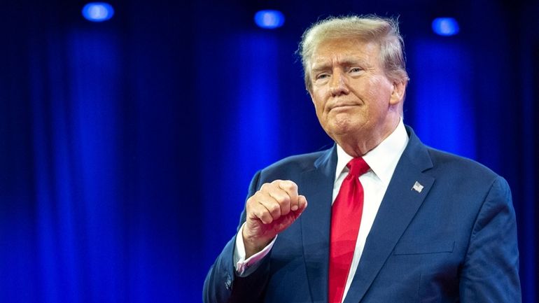 Republican presidential candidate former President Donald Trump pumps his fist...