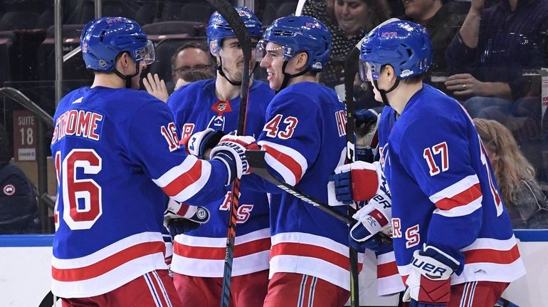 Rangers players congratulate defenseman Libor Hajek (43) after he scores...