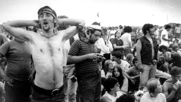 Music fans relax during a break in the entertainment at...