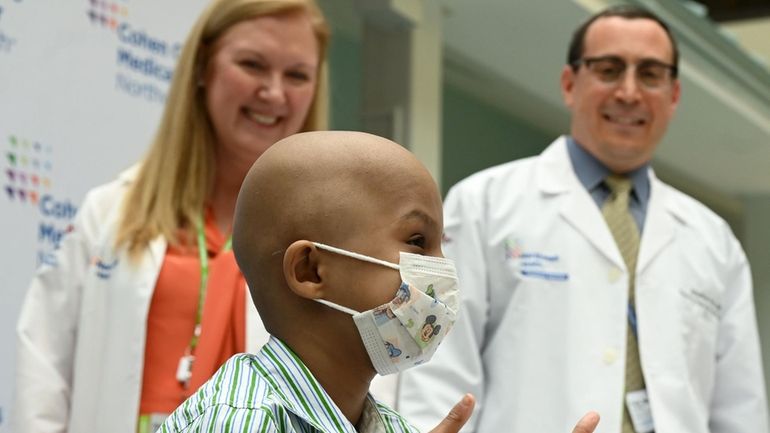 Yusef Saeed, 8, gives a thumbs-up after speaking at a...