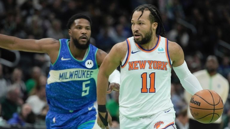 Knicks' Jalen Brunson drives past Milwaukee Bucks' Malik Beasley during...