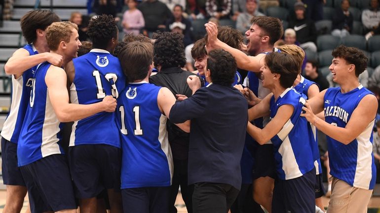 Calhoun boys volleyball players celebrate after their 3-0 win over...