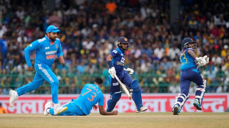 India's Mohammed Siraj loses his balance after delivering a ball...