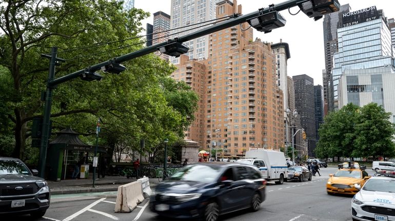 License-plate reading devices mounted above traffic near Manhattan's West 60th Street...