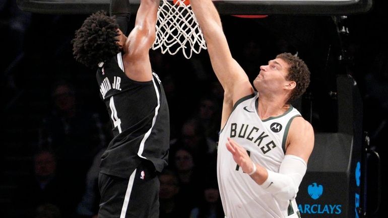 Dennis Smith Jr. of the Nets scores on Brook Lopez of the...