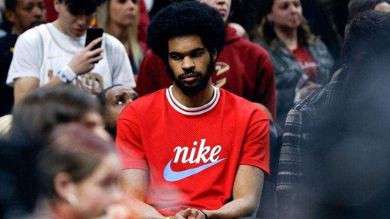 Injured Cleveland Cavaliers center Jarrett Allen sits on the bench...