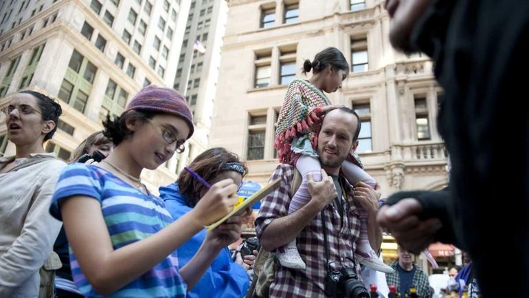 Orin Herskowikz carries his 6-year-old daughter Melina Ahmad on his...