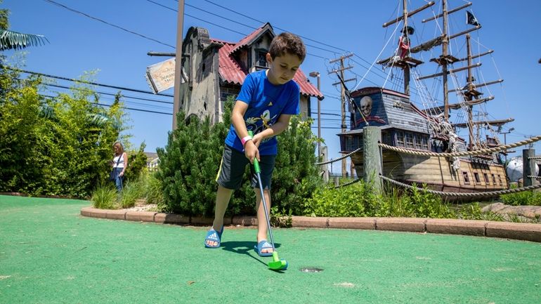 Vasilios Moustakakis, of Syosset, plays mini golf at Bayville Adventure...