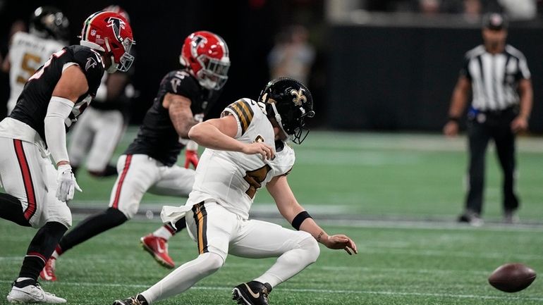 New Orleans Saints quarterback Derek Carr (4) fumbles the ball...