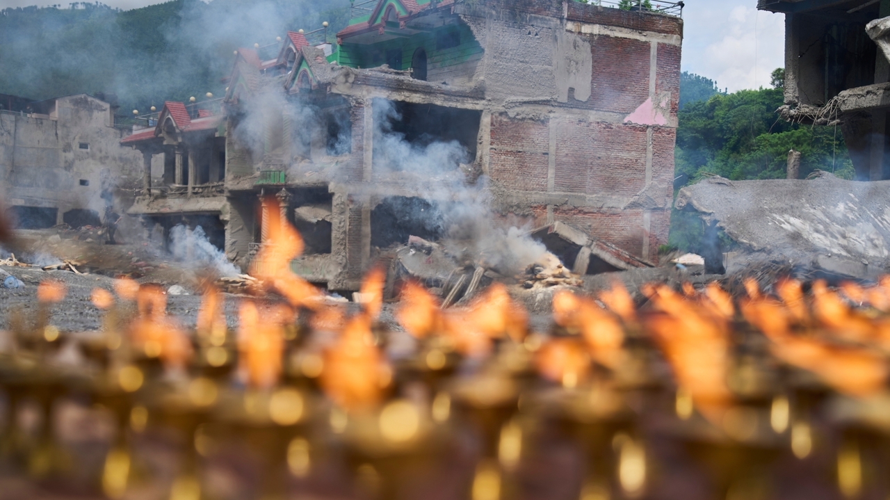 Nepal holds a day of mourning after floods kill more than 1,300 people