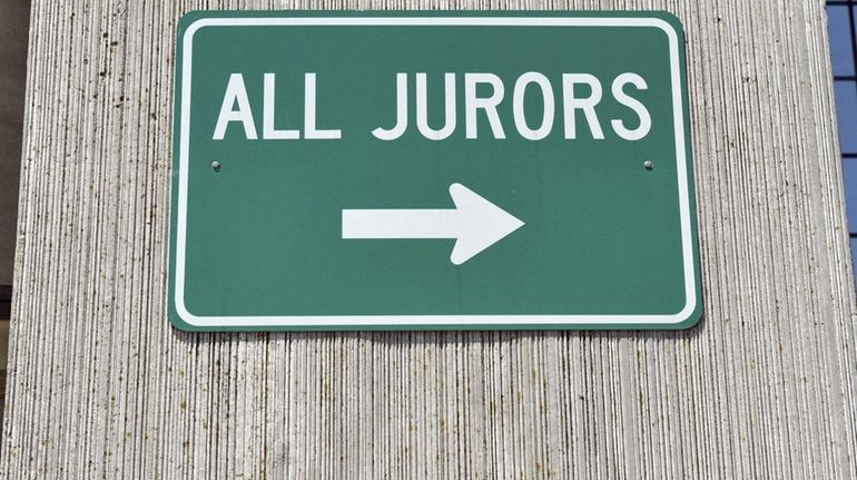 A sign pointing to the jurors' entrance at the Arthur...