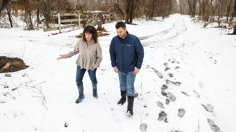 Julie Wesnofske, project manager at the Peconic Land Trust, and...