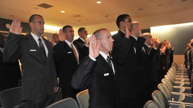 Some of the new Suffolk police recruits are sworn by...