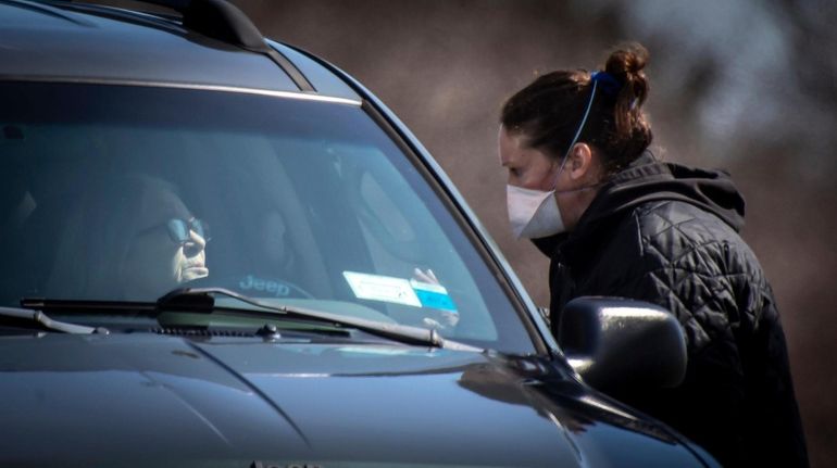 A woman assists a driver with an appointment at the...