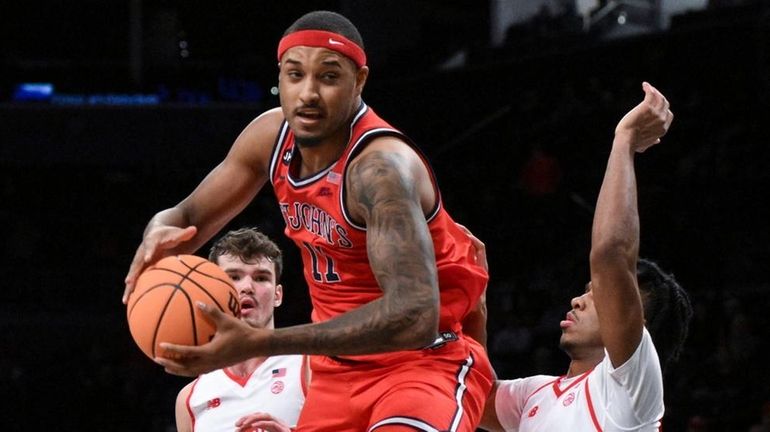 St. John's center Joel Soriano looks to score while defended...